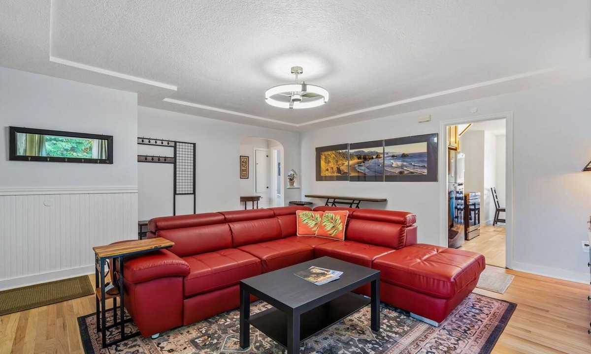 Downtown Vancouver House | Freshly renovated home with brand-new appliances, a new big-screen TV, refinished hardwood floors, and all-new furniture throughout. Sink into the plush leather sectional (pull-out queen sleeper) or dine at the six-seat table in the garden.