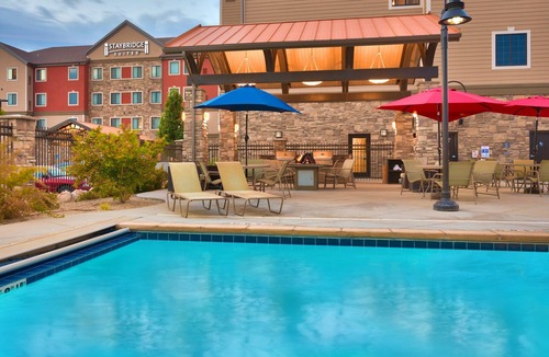 Midvale Apartment | King Suite | Heated Pool & Hot Tub. Free Breakfast Buffet. Near Jordan Landing!