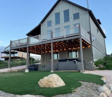 Harbor Village House | Putting green with hot tub, swings and spectacular views